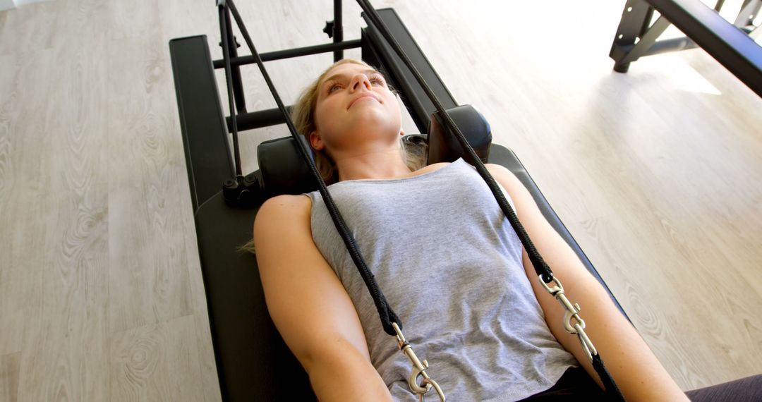 Young Woman Exercising on Pilates Reformer Machine in Fitness Studio - Free Images, Stock Photos and Pictures on Pikwizard.com