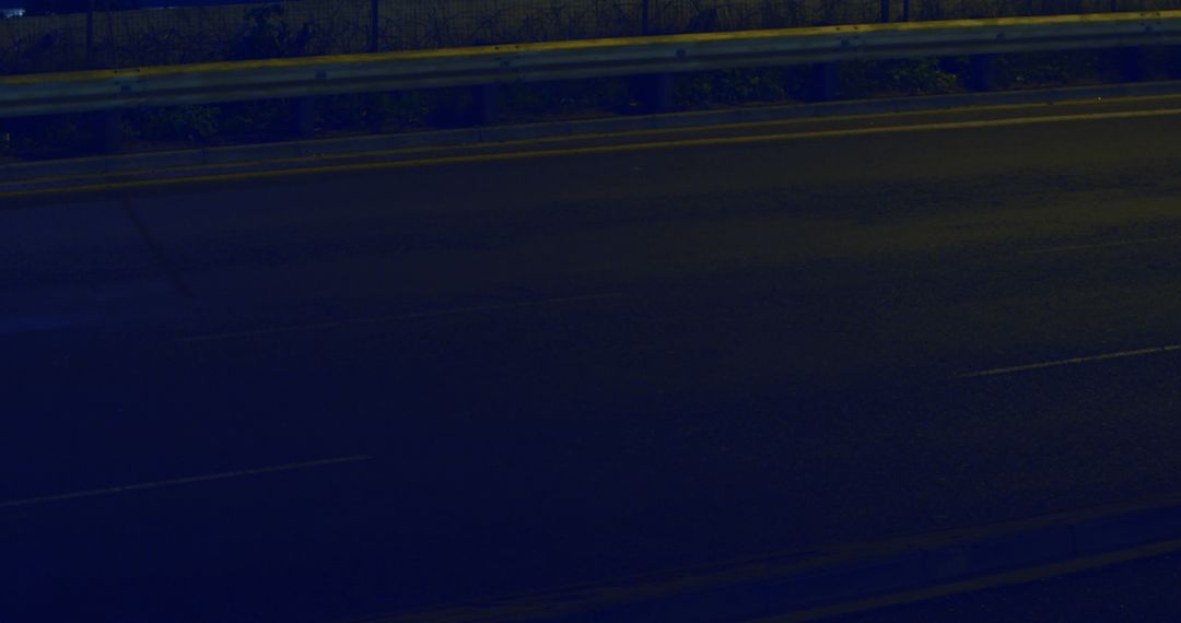 Empty Urban Highway at Twilight with Metal Guardrail