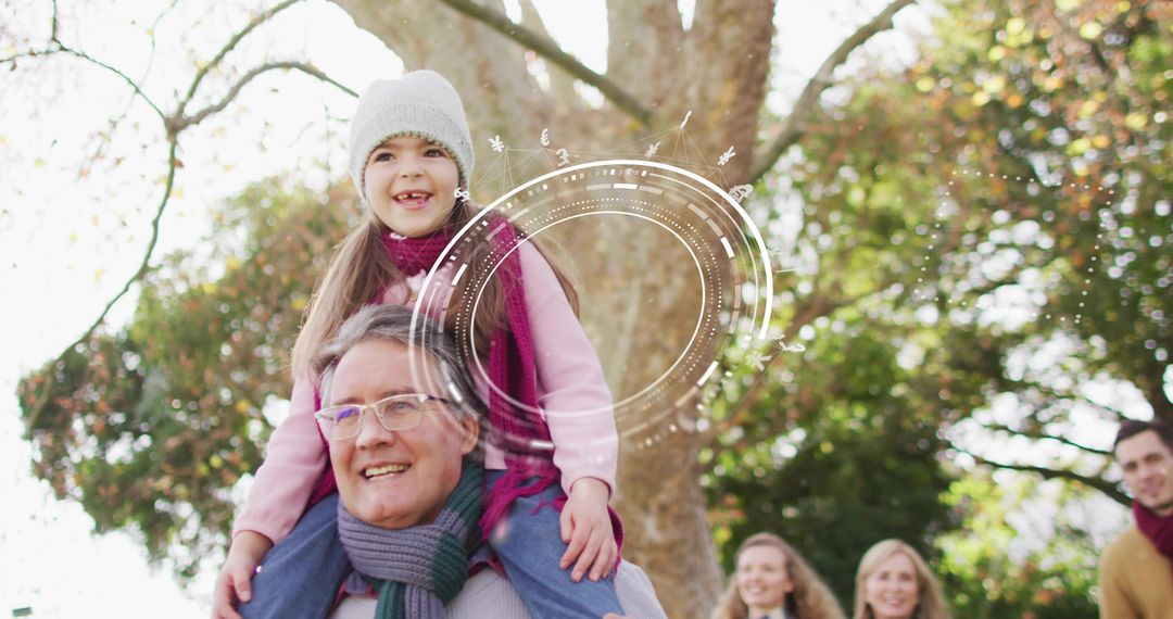 Grandfather carrying granddaughter on shoulders in autumn park, smiling family enjoying moment
