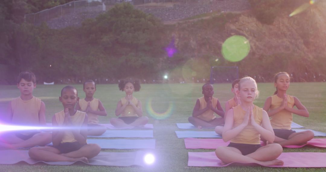 Diverse Children Practicing Yoga in Sunlit Field