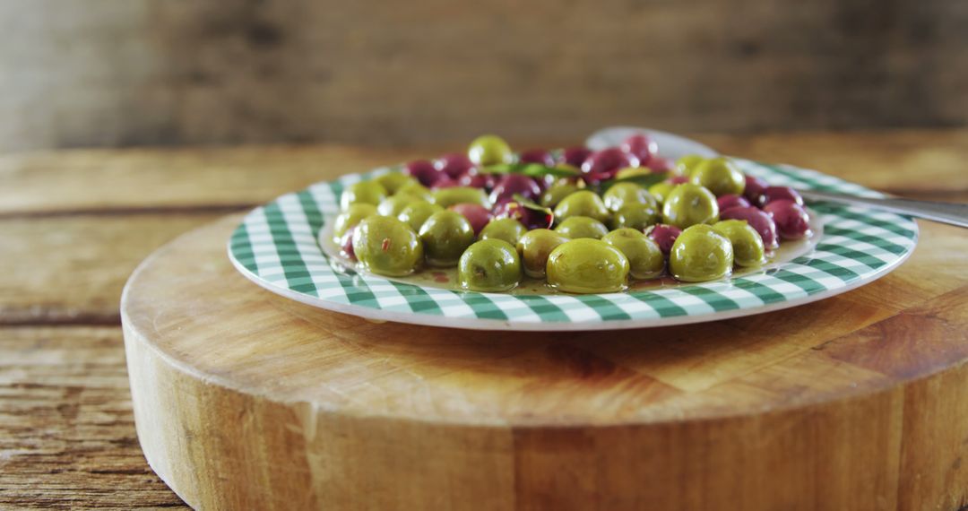 Close-up Plate with Green and Purple Olives on Wood Table - Free Images, Stock Photos and Pictures on Pikwizard.com