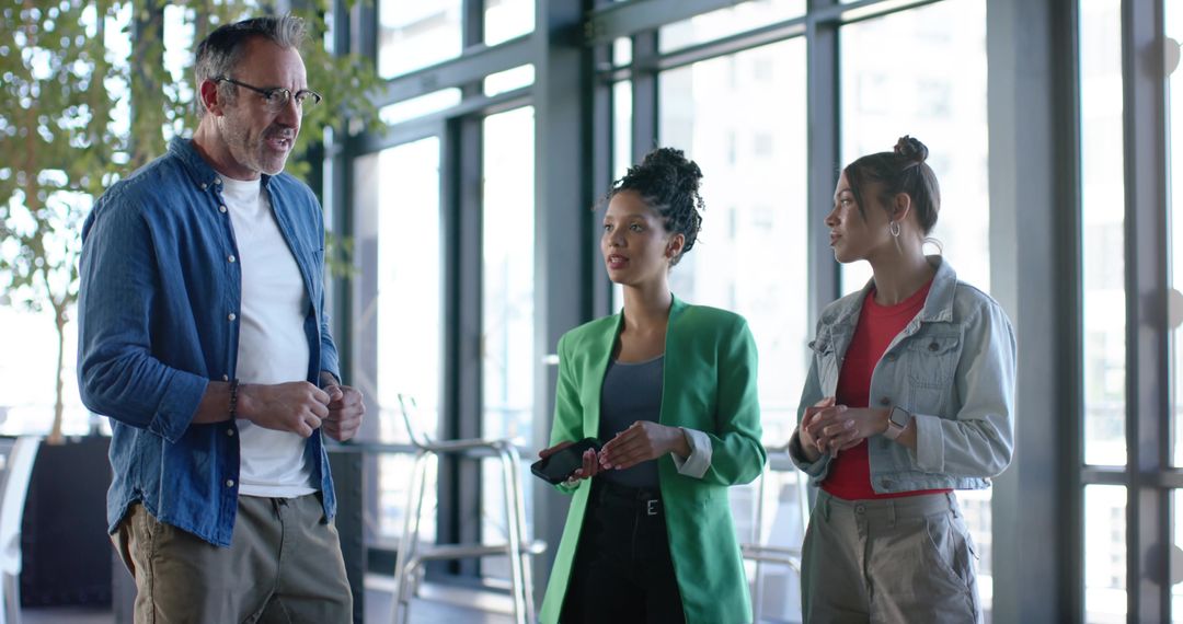Multicultural Team Discussing Project Strategy in Bright Glass Office with City View