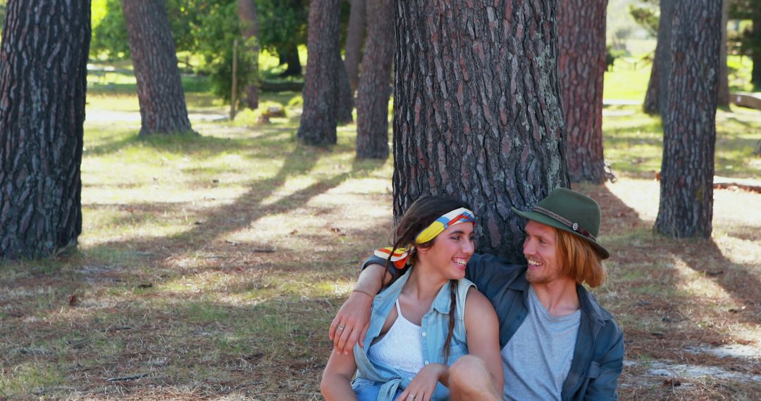 Young Couple Relaxing in Forest Together Enjoying Nature - Free Images, Stock Photos and Pictures on Pikwizard.com