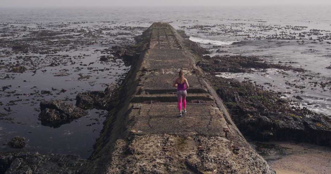 Woman Jogging on Coastal Pathway - Free Images, Stock Photos and Pictures on Pikwizard.com