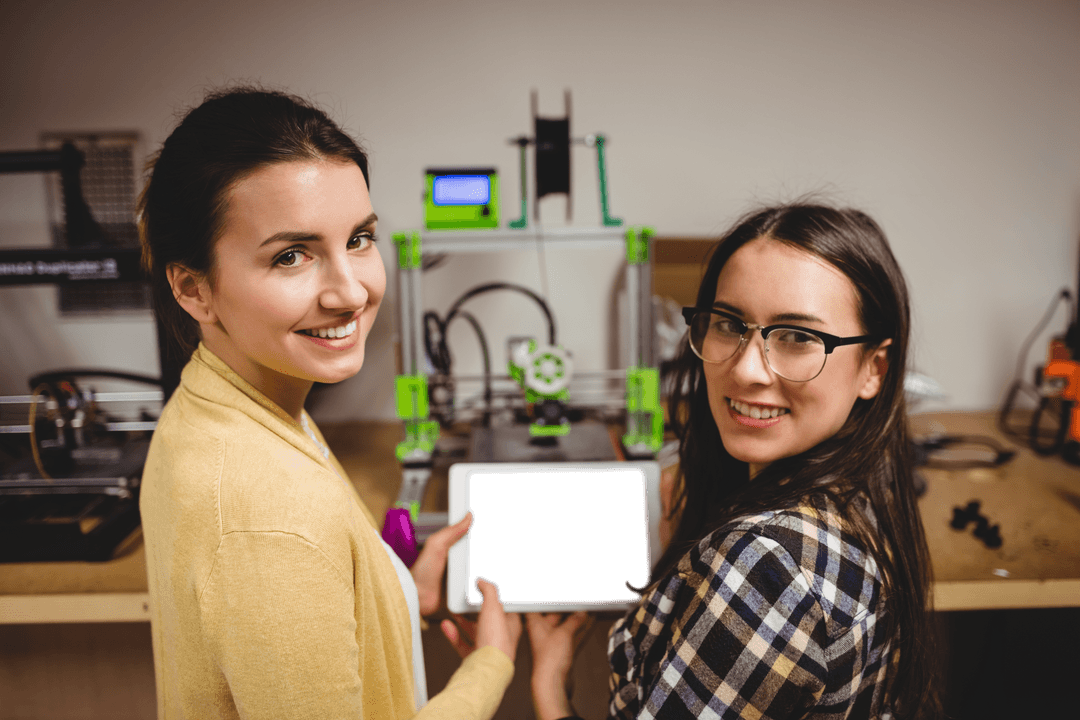Smiling Women Designers Showing Transparent Tablet Screen in Creative Studio