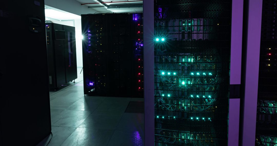 Data Center Corridor with Illuminated Servers in Dark Room