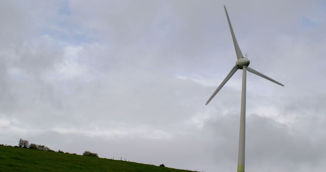 Lone Wind Turbine on a Cloudy Day in the Countryside - Free Images, Stock Photos and Pictures on Pikwizard.com