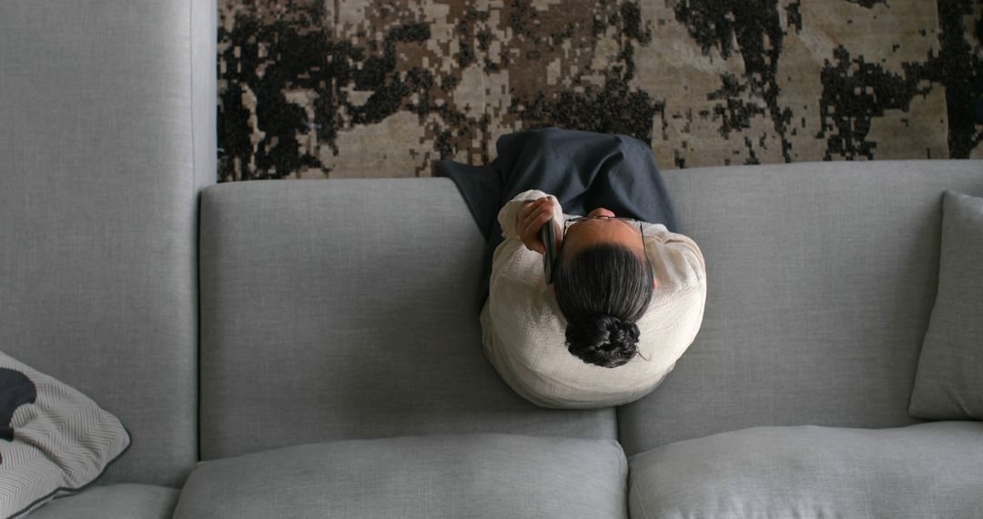 Top View of Woman Relaxing on Sofa with Cozy Blanket - Free Images, Stock Photos and Pictures on Pikwizard.com