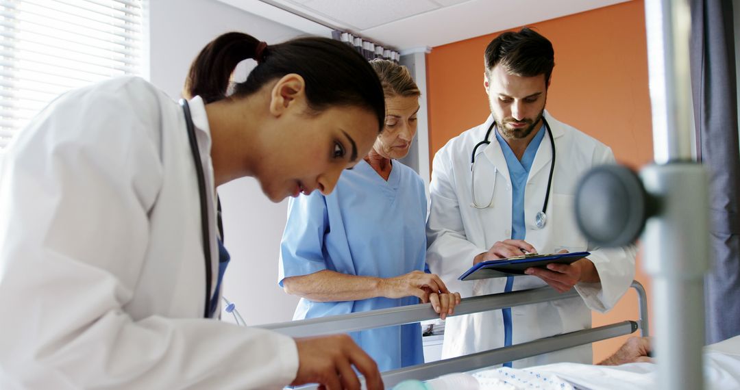 Medical Team Examining Patient in Hospital Room - Free Images, Stock Photos and Pictures on Pikwizard.com