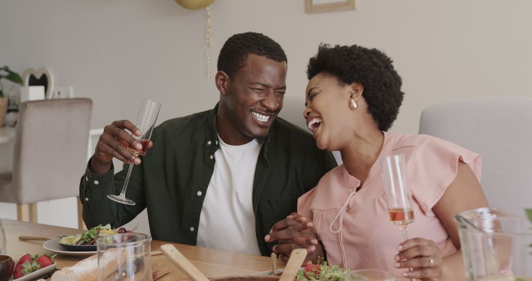 Joyful Friends Sharing Toasts Around Dinner Table