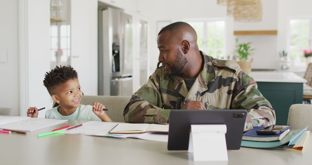 Father in Military Uniform Bonding with Son Over Homework