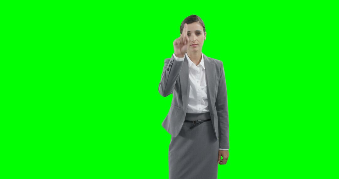 Businesswoman Pointing at Screen with Green Background - Free Images, Stock Photos and Pictures on Pikwizard.com