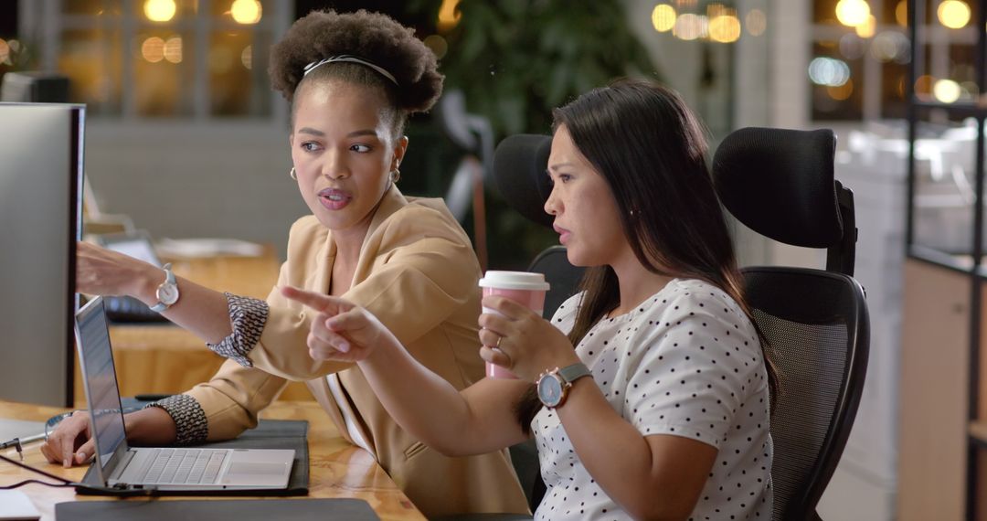 Colleagues Collaborating with Laptop and Coffee in Professional Office