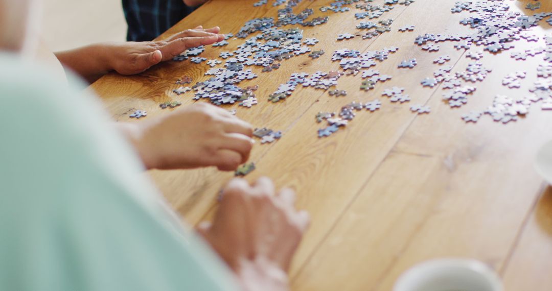 Family Bonding Over Jigsaw Puzzle On Wooden Table - Free Images, Stock Photos and Pictures on Pikwizard.com