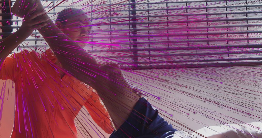 Performers touching neon fiber-optic strands in interactive installation studio performance