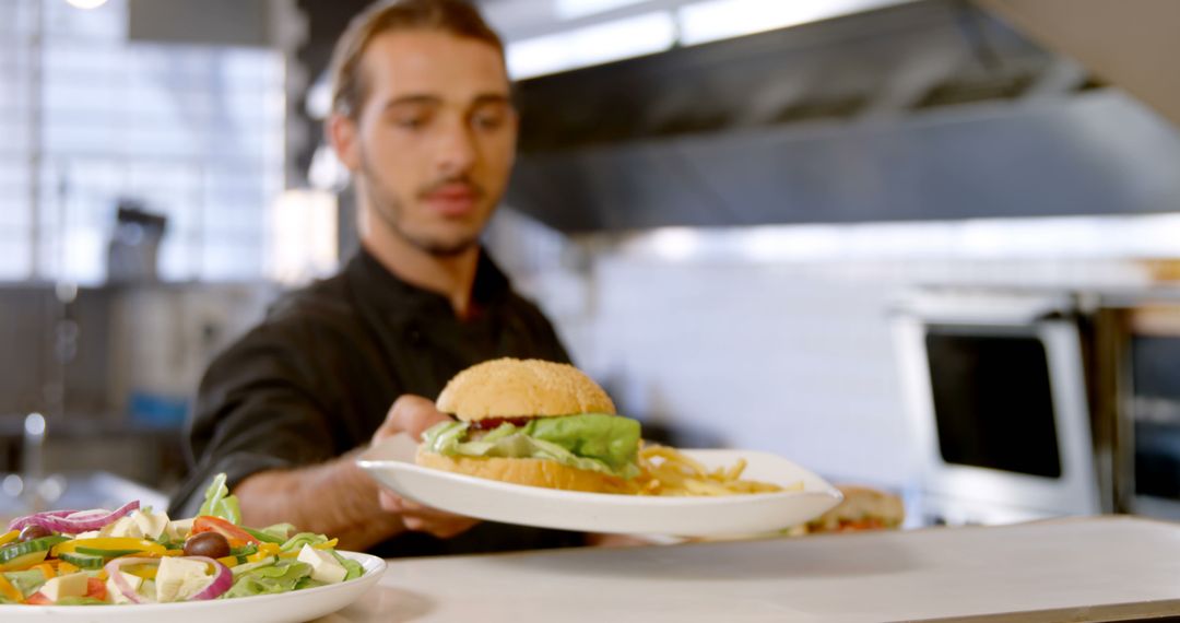 Chef Serving Fresh Burger and Fries in Restaurant Kitchen - Free Images, Stock Photos and Pictures on Pikwizard.com