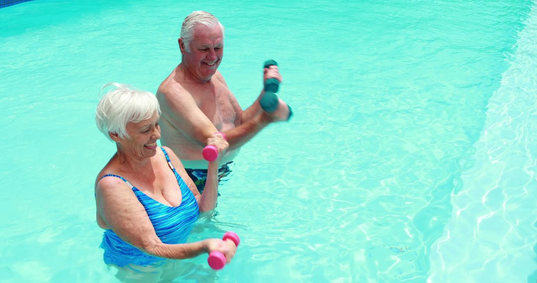 Senior Couple Enjoying Aquatic Exercise in Pool - Free Images, Stock Photos and Pictures on Pikwizard.com