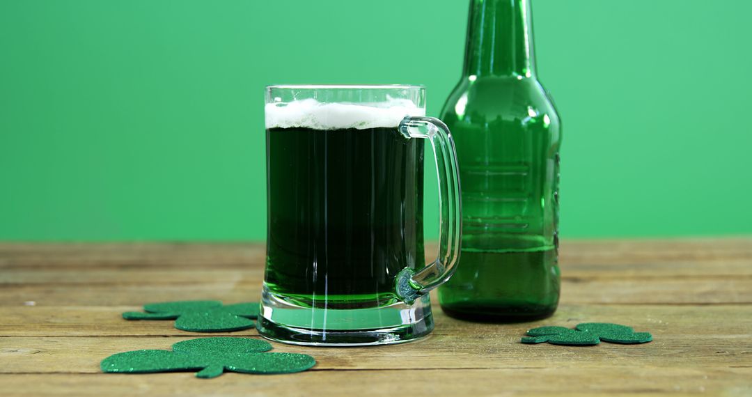 Green Beer in a Mug and Bottle on a Wooden Table for St. Patrick's Day Celebration - Free Images, Stock Photos and Pictures on Pikwizard.com