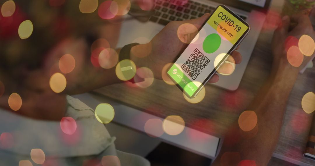 Man Holding Smartphone with COVID-19 Vaccine Passport Amid Bokeh Lights