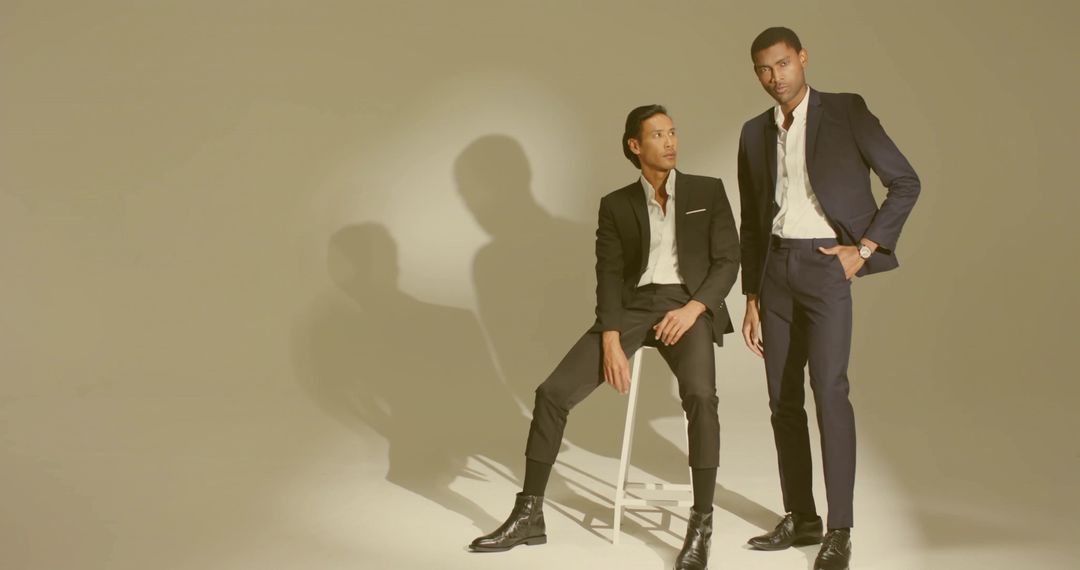 Stylish Men in Elegant Tailored Suits Posed in Studio