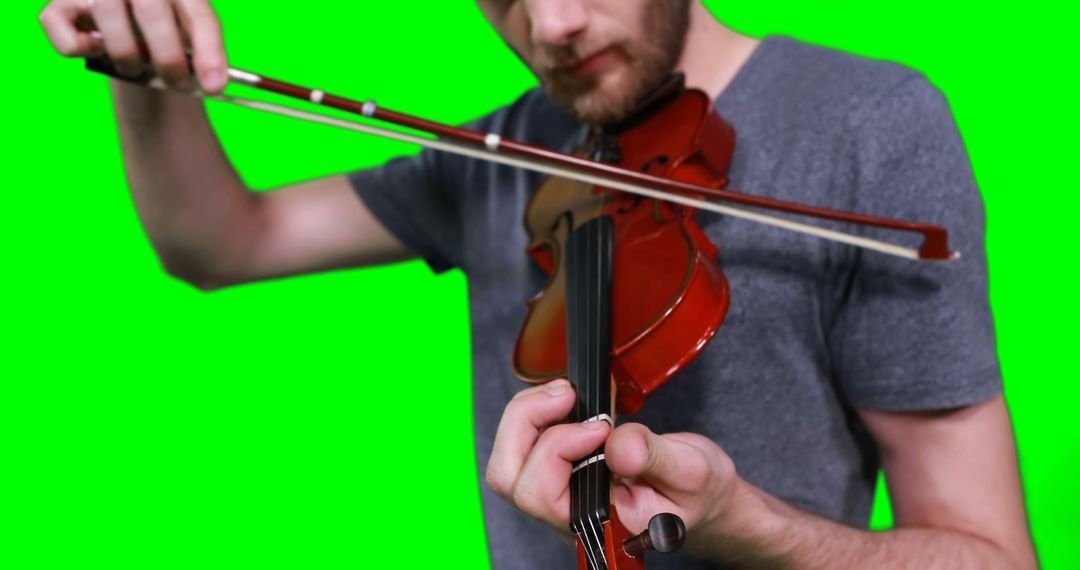Male musician playing violin against green screen - Free Images, Stock Photos and Pictures on Pikwizard.com