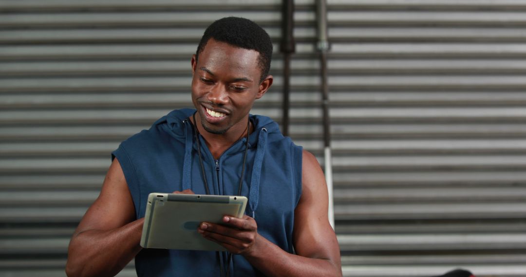 Athletic Man Using Tablet in Modern Gym - Free Images, Stock Photos and Pictures on Pikwizard.com