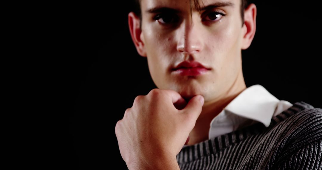 Young Man Posing Thoughtfully Against Black Background - Free Images, Stock Photos and Pictures on Pikwizard.com