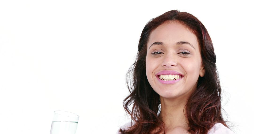 Young Woman Smiling Holding Glass of Water - Free Images, Stock Photos and Pictures on Pikwizard.com