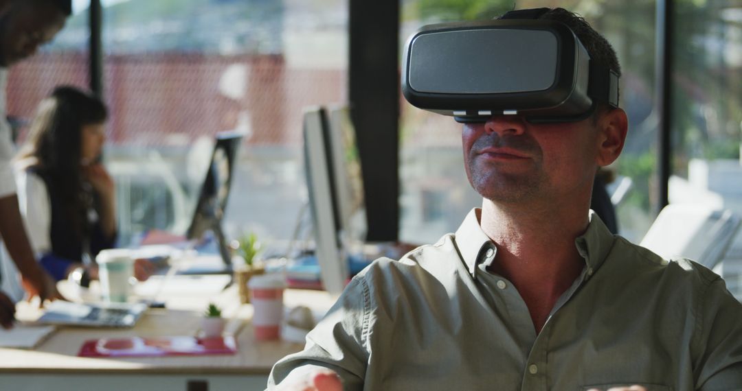 Man Using Virtual Reality Headset in Modern Office Environment - Free Images, Stock Photos and Pictures on Pikwizard.com