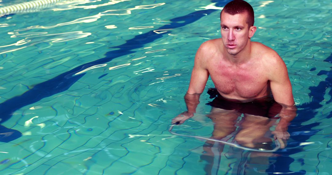 Middle-Aged Man Standing in Swimming Pool Looking Focused - Free Images, Stock Photos and Pictures on Pikwizard.com