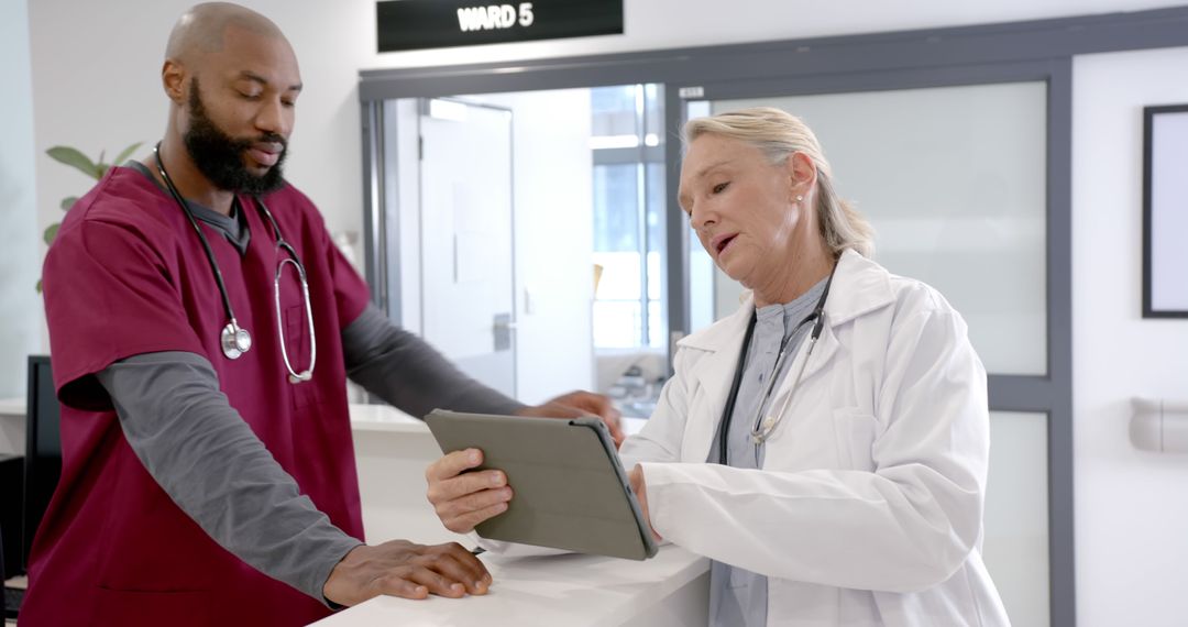 Hospital Staff Collaborating on Patient Information Using Tablet - Free Images, Stock Photos and Pictures on Pikwizard.com