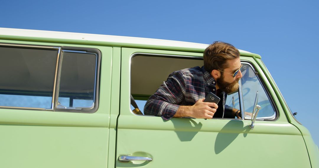 Road Trip Adventure, Man Leaning Out Green Van Window Holding Camera - Free Images, Stock Photos and Pictures on Pikwizard.com