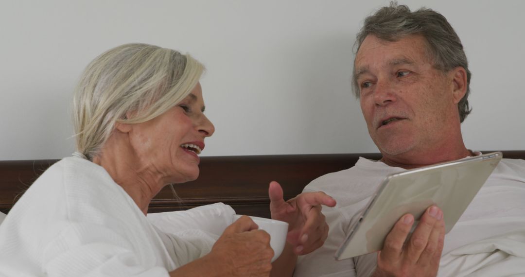 Senior Couple Enjoying Morning Together with Tablet