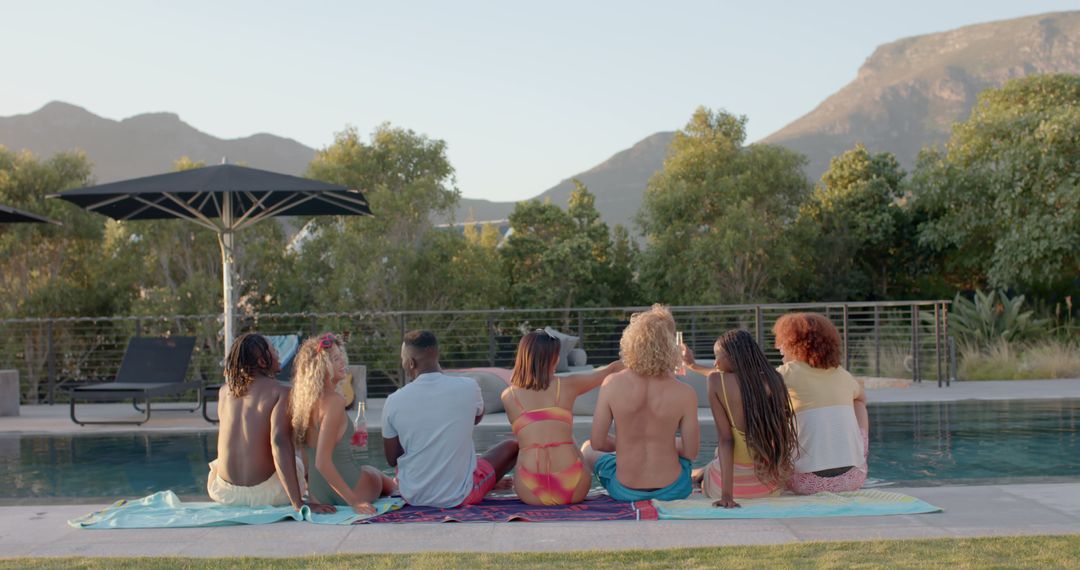 Diverse Friends Relaxing at Poolside with Scenic Mountain Views - Free Images, Stock Photos and Pictures on Pikwizard.com