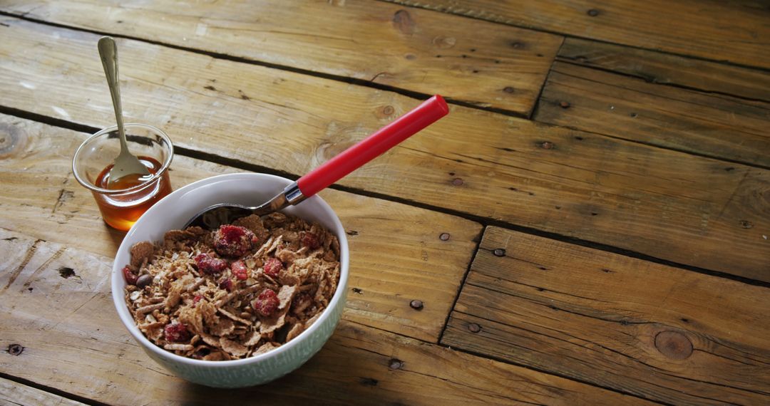 Healthy Breakfast Bowl with Granola and Honey on Wooden Table - Free Images, Stock Photos and Pictures on Pikwizard.com