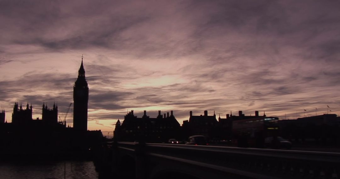Silhouetted Cityscape at Dusk with Clock Tower and Skyline
