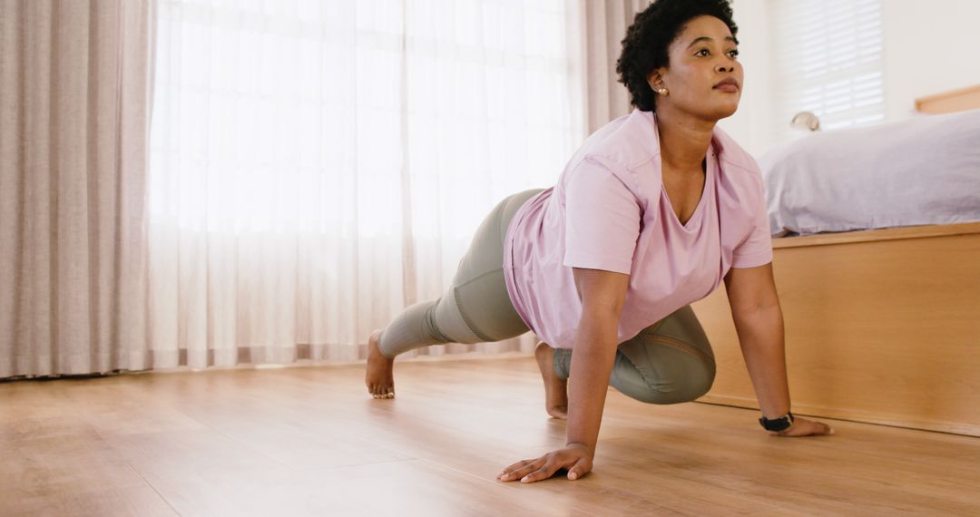 Woman Practicing Yoga at Home on Wooden Floor - Free Images, Stock Photos and Pictures on Pikwizard.com