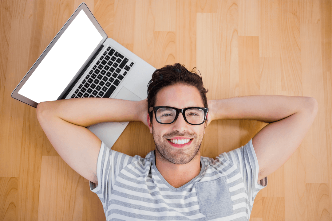 Happy Man with Laptop Lying on Hardwood Floor, Transparent Screen