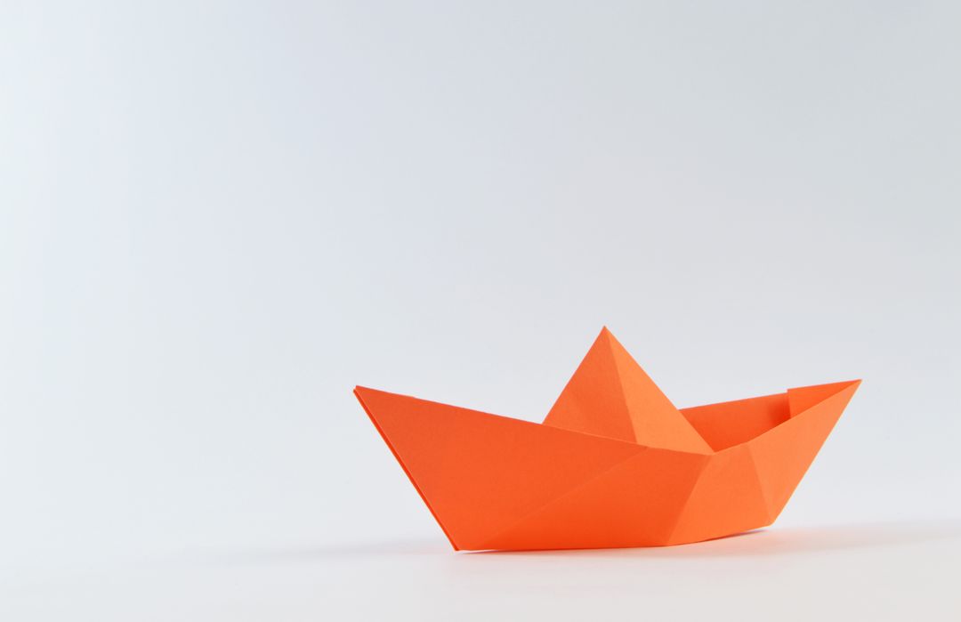 Minimalistic Orange Paper Boat on White Background - Free Images, Stock Photos and Pictures on Pikwizard.com