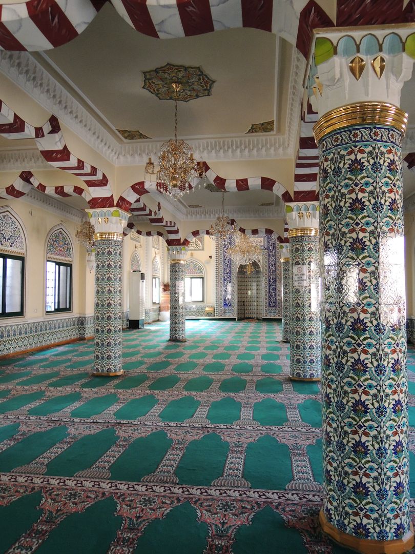 Ornate Interior of an Empty Mosque with Decorative Columns
