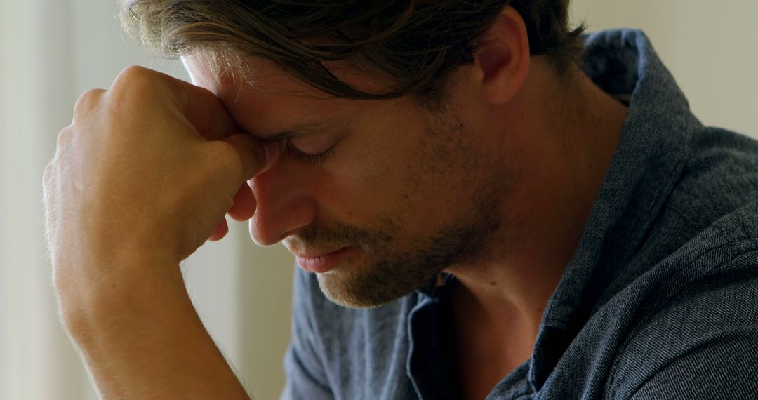 Stressed Man Holding Head in Hands, Close-up - Free Images, Stock Photos and Pictures on Pikwizard.com