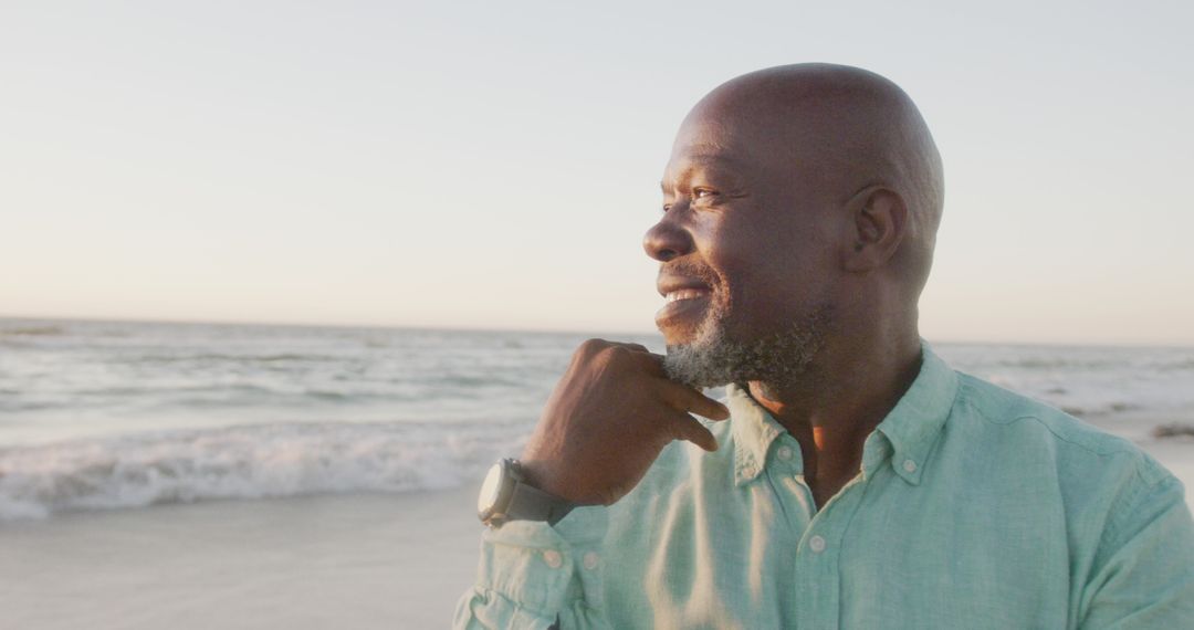 Smiling Man Enjoying Serene Beach Sunset - Free Images, Stock Photos and Pictures on Pikwizard.com