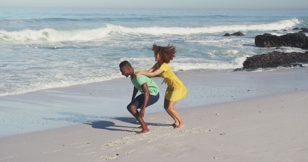 Couple Playing Piggyback Ride on Sunny Beach - Free Images, Stock Photos and Pictures on Pikwizard.com