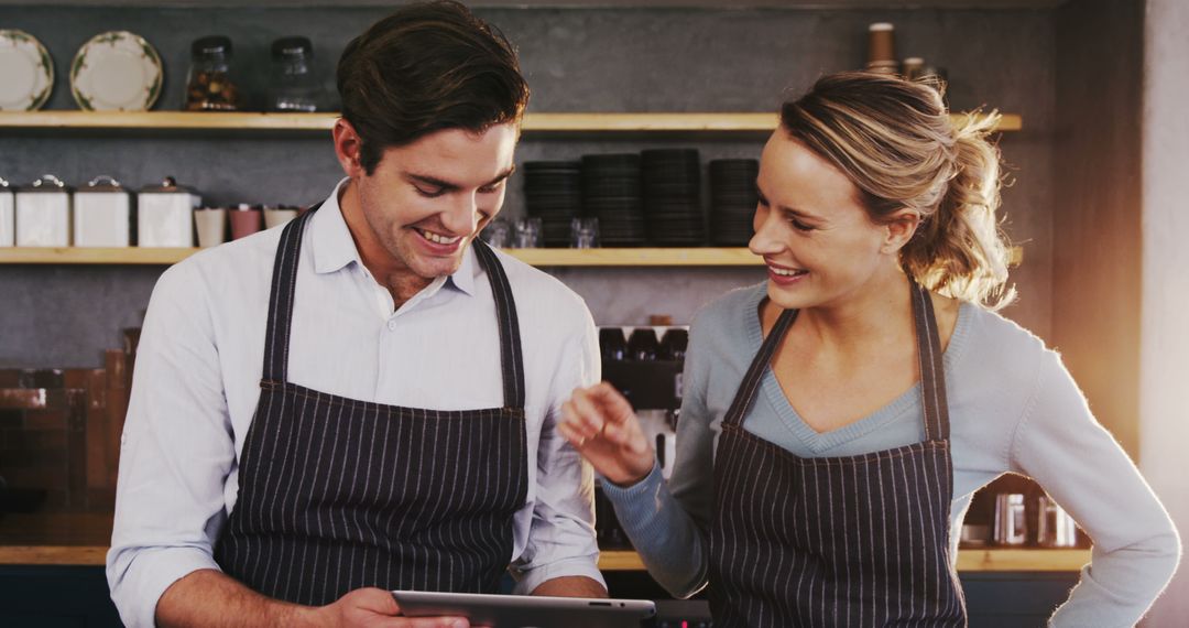 Cafe Employees Checking Orders on Tablet, Smiling Teamwork - Free Images, Stock Photos and Pictures on Pikwizard.com