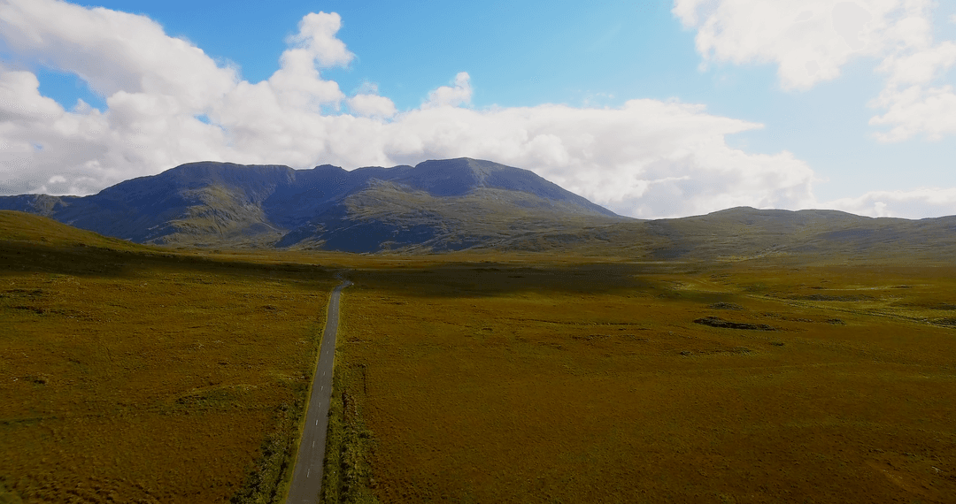 Transparent Sky Over Serene Mountain Valley with Long Road