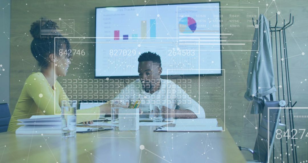 Colleagues Analyzing Data with Digital Interface Overlay in Office