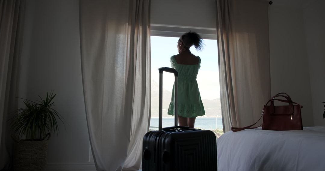 Woman by Window with Suitcase in Tranquil Bedroom Setting for Travel Lifestyle
