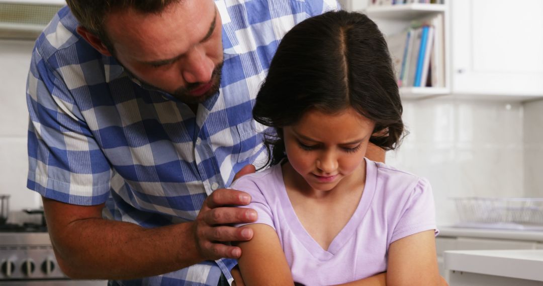 Concerned Father Comforts Upset Daughter in Kitchen - Free Images, Stock Photos and Pictures on Pikwizard.com