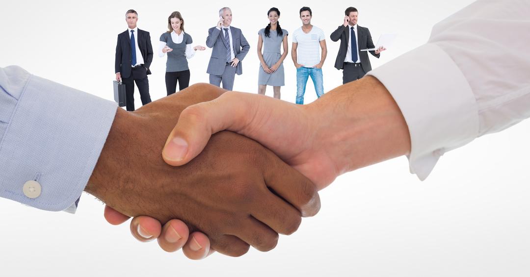 Cropped image of business people doing handshake with employees in background - Free Images, Stock Photos and Pictures on Pikwizard.com