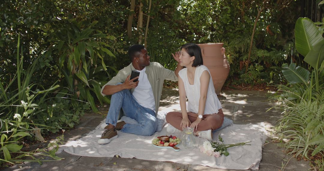 Romantic Couple Enjoying Picnic Together in Serene Garden